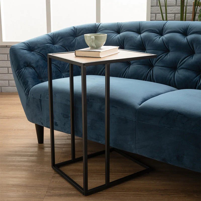 Blue velvet sofa side angle with black oak legs
